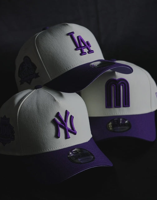 New Era white with purple letter baseball team hats